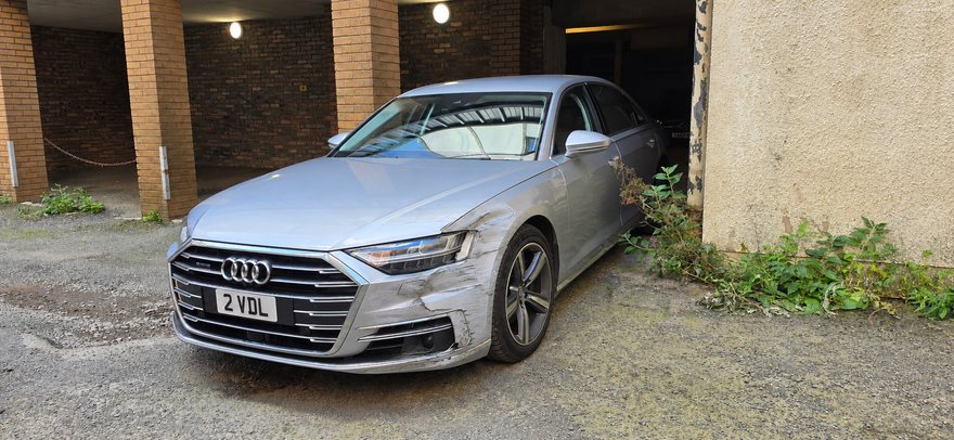 The same silver car, apparently with damage to the front wing and bumper